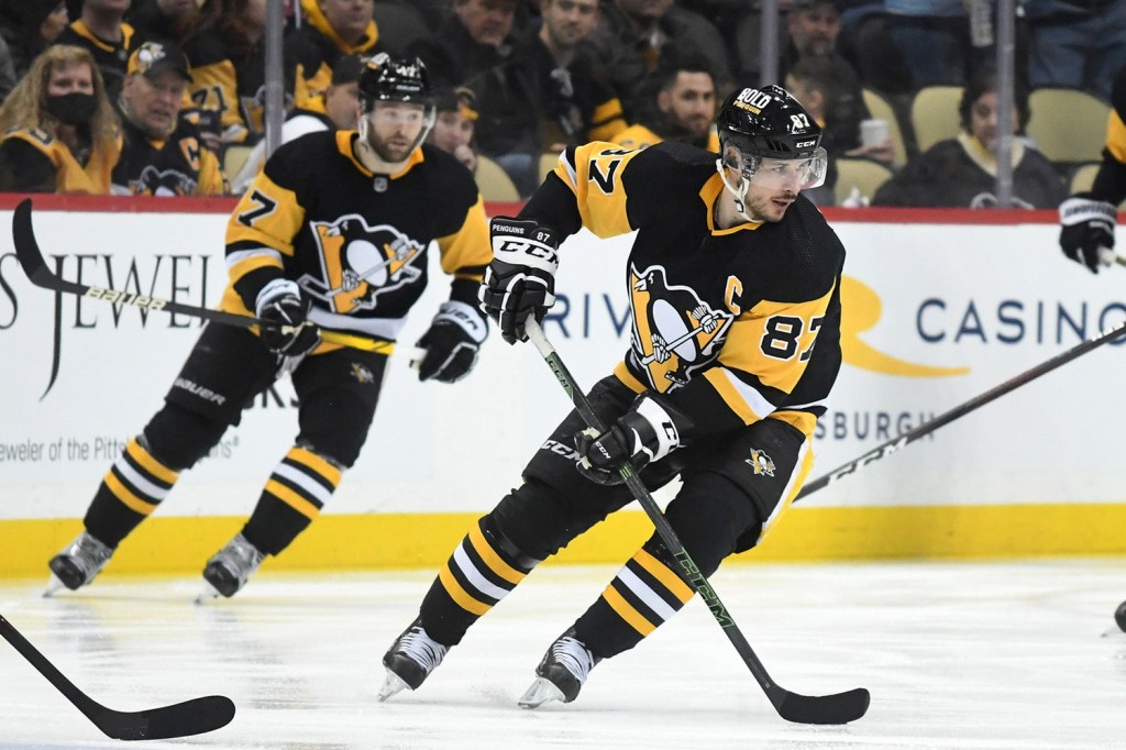 Pittsburgh Penguins forward Sydney Crosby skates with puck down ice