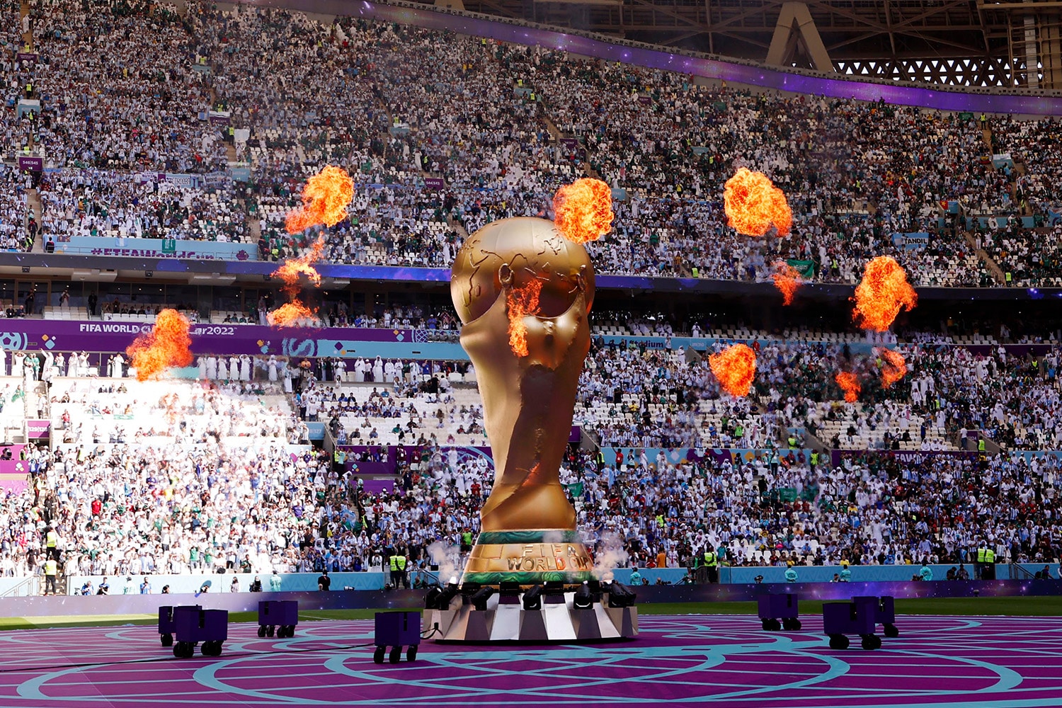 Large replica of World Cup trophy inside of stadium in Qatar
