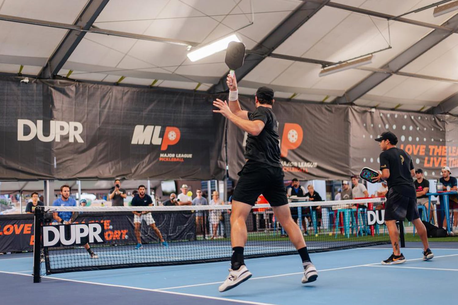 Men play a doubles game of pickle ball on the Major League Pickleball circuit