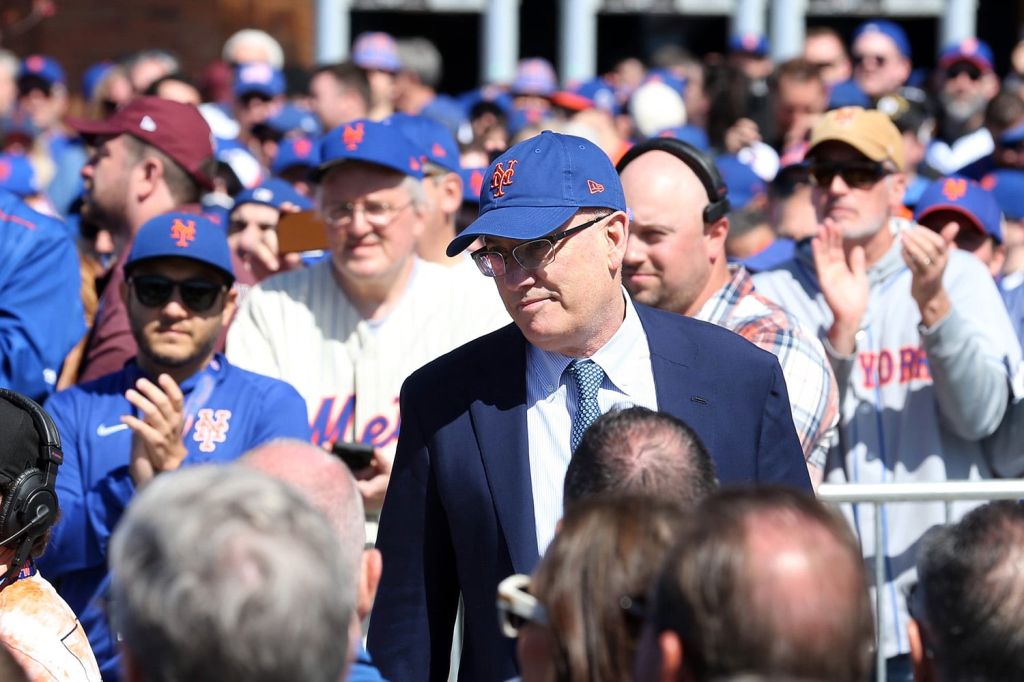 Team owner Steve Cohen sitting with fans in the stands of a Mets game