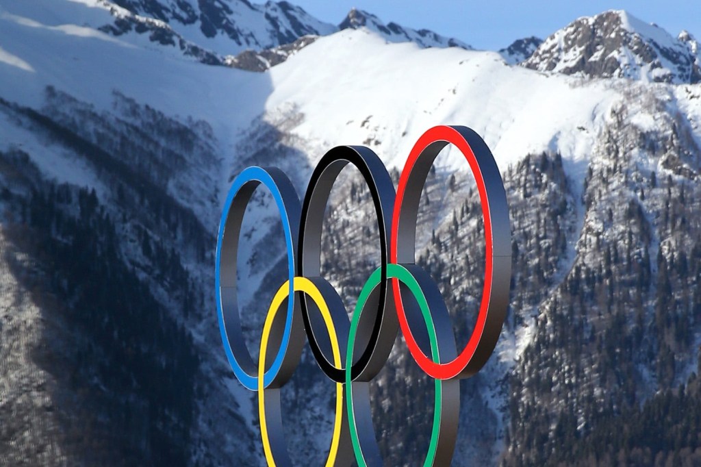Olympic rings in front of mountains in the background