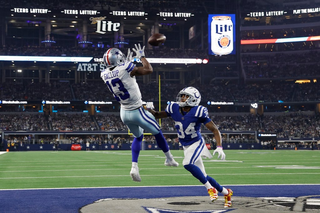 Dallas Cowboys receiver Michael Gallup completes touchdown catch while jumping over Indianapolis Colts defender
