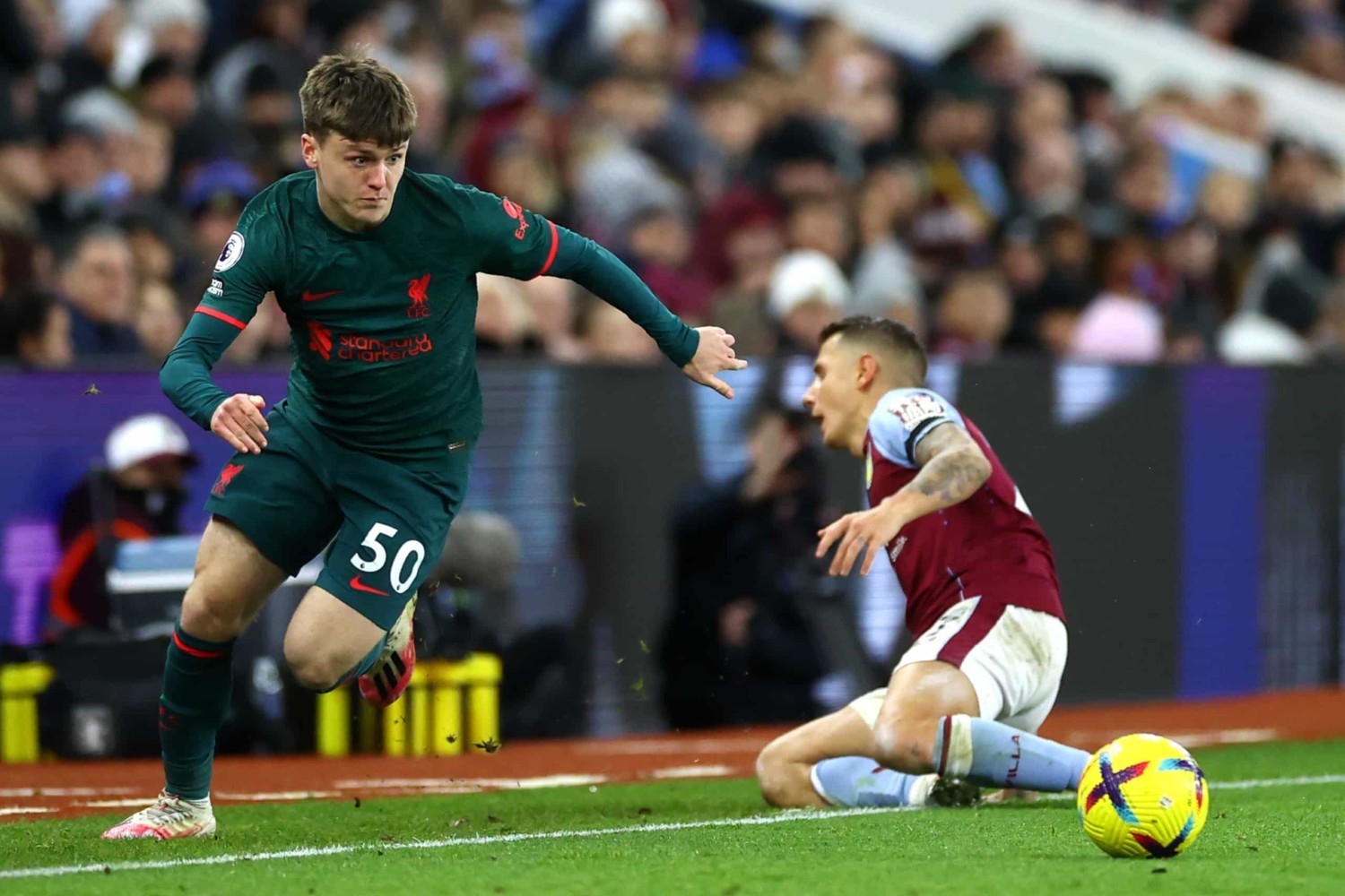 Liverpool attacker Ben Doak accelerates past Aston Villa defender