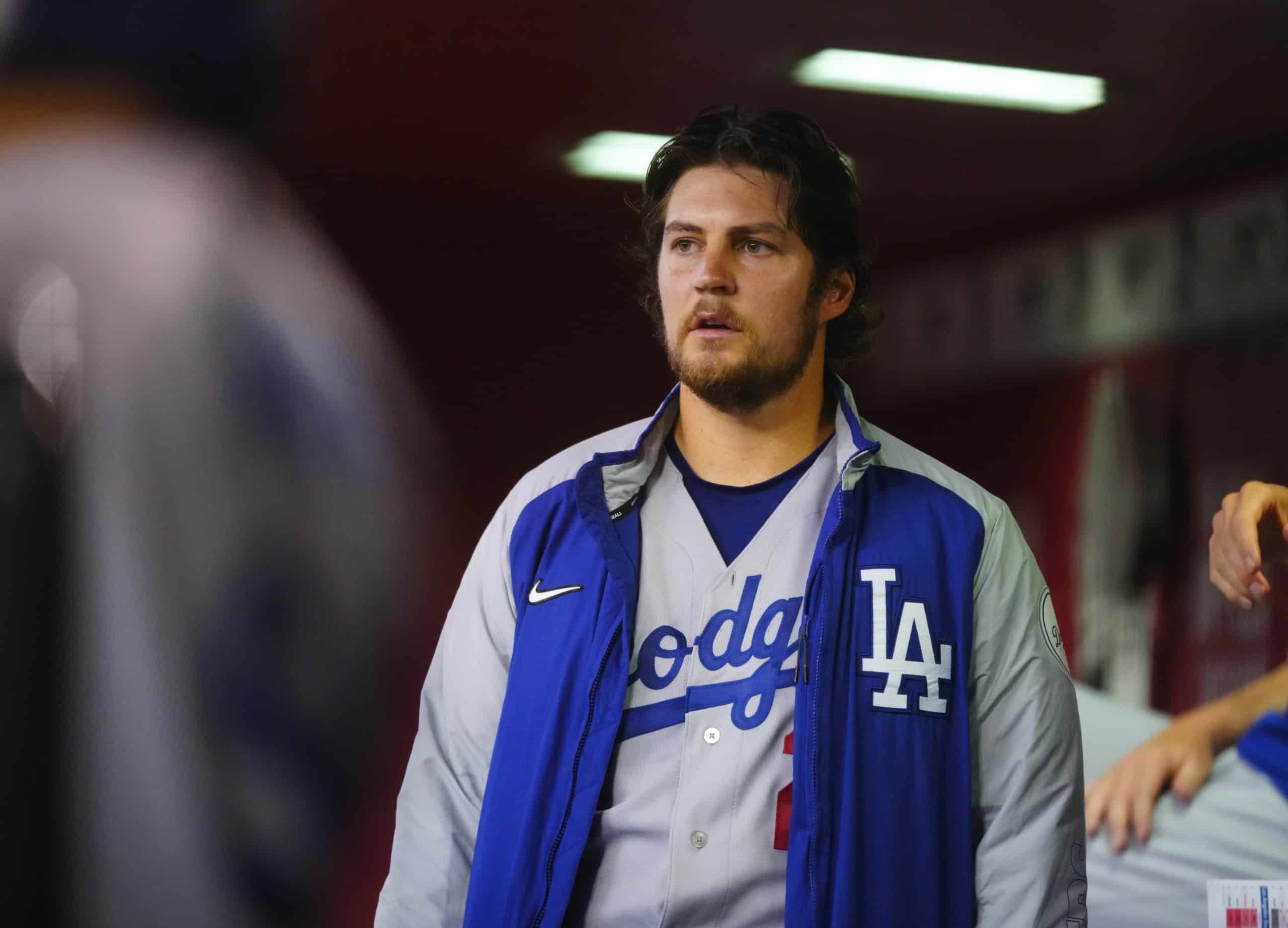 Los Angeles Dodgers pitcher Trevor Bauer stands in dugout