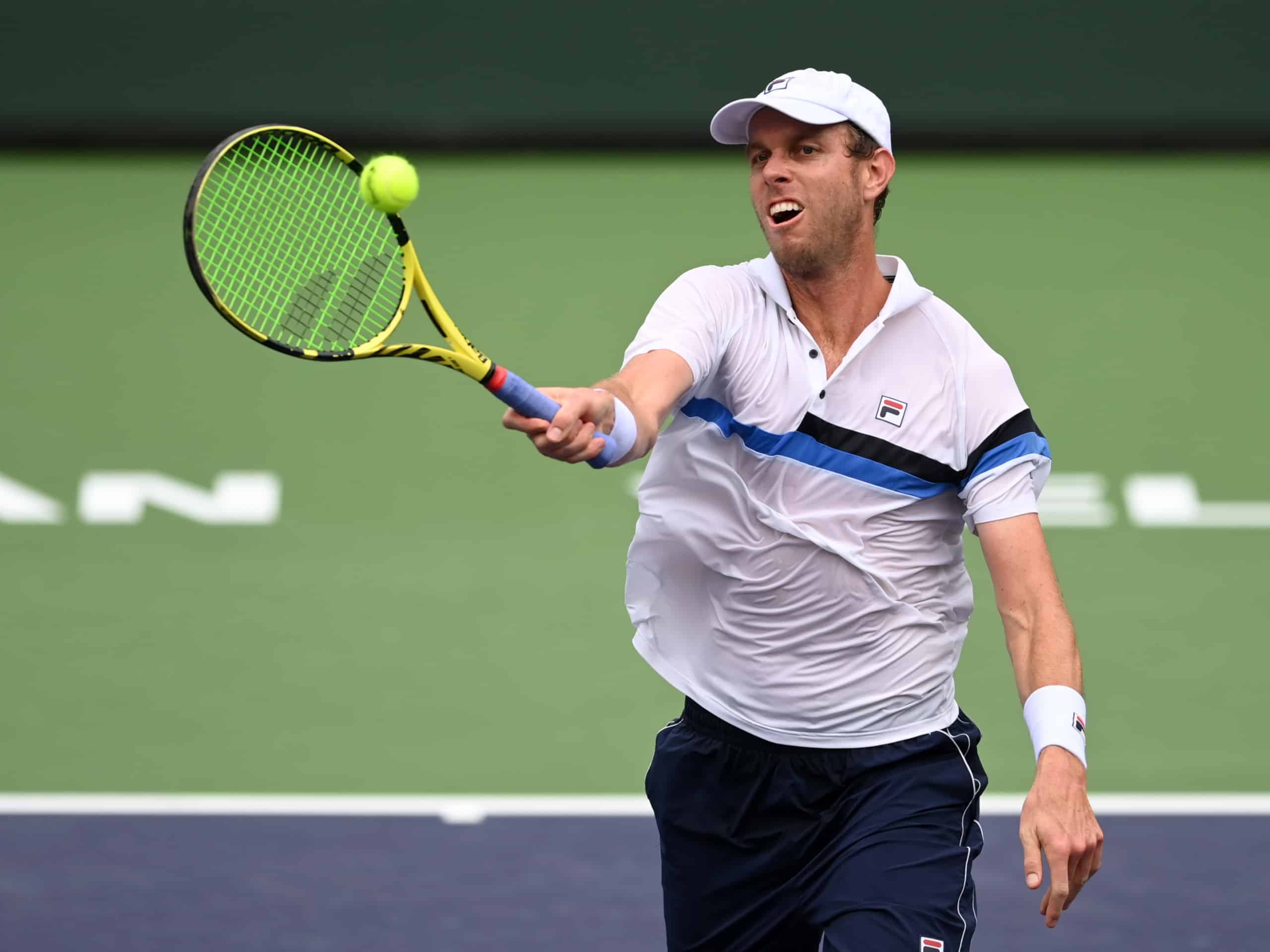 Former ATP tennis player Sam Querrey returns shot