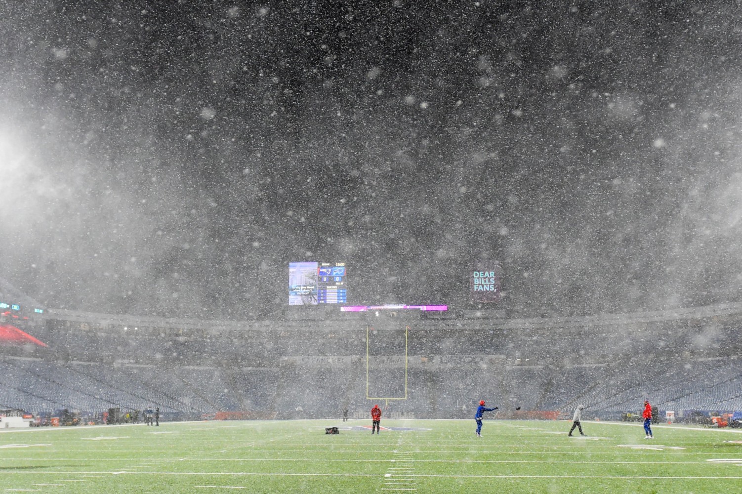 Players warming up in snow for NFL game in Buffalo