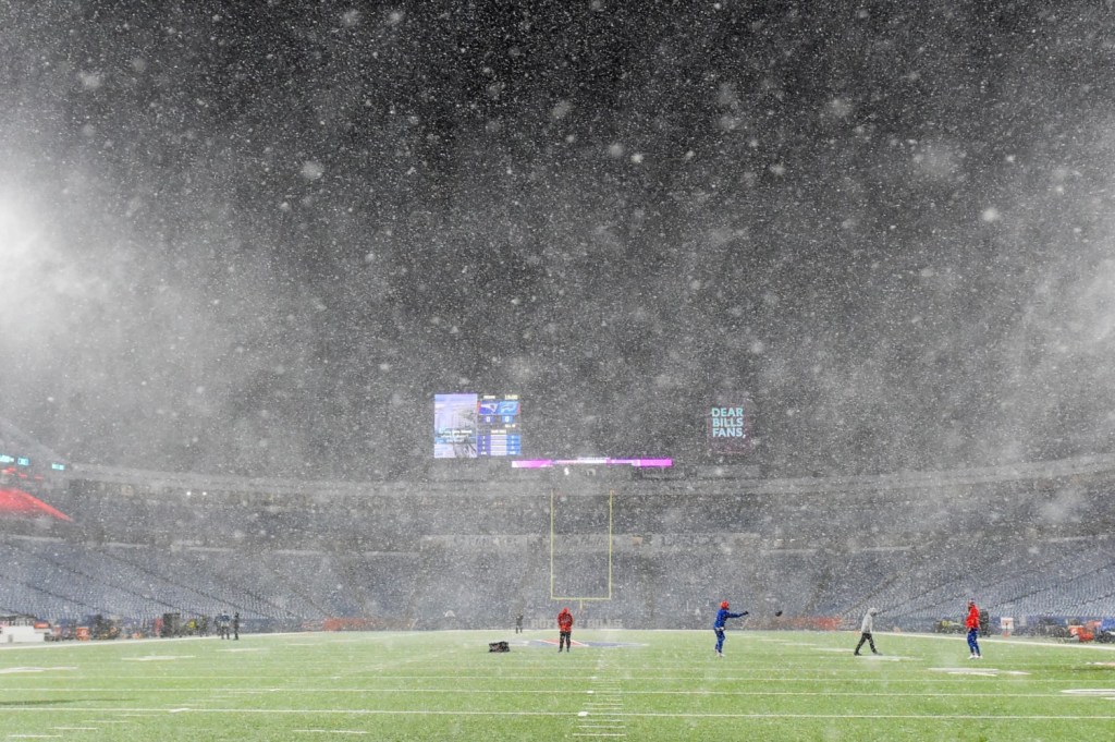 Players warming up in snow for NFL game in Buffalo