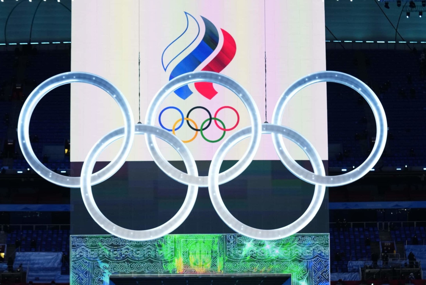 Olympics rings in front of large screen