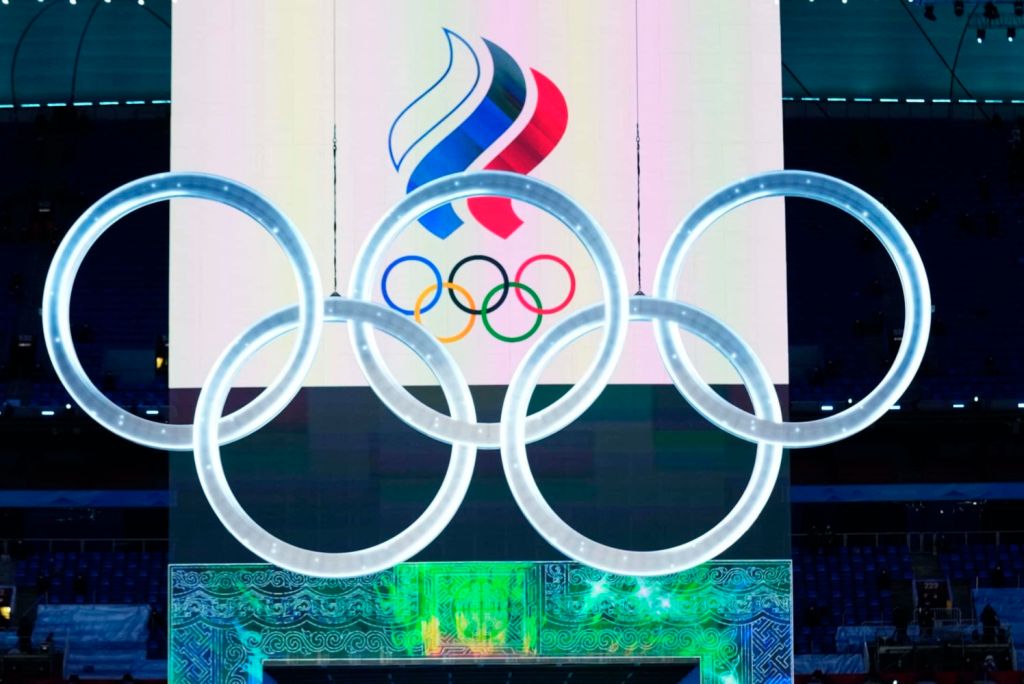 Olympics rings in front of large screen