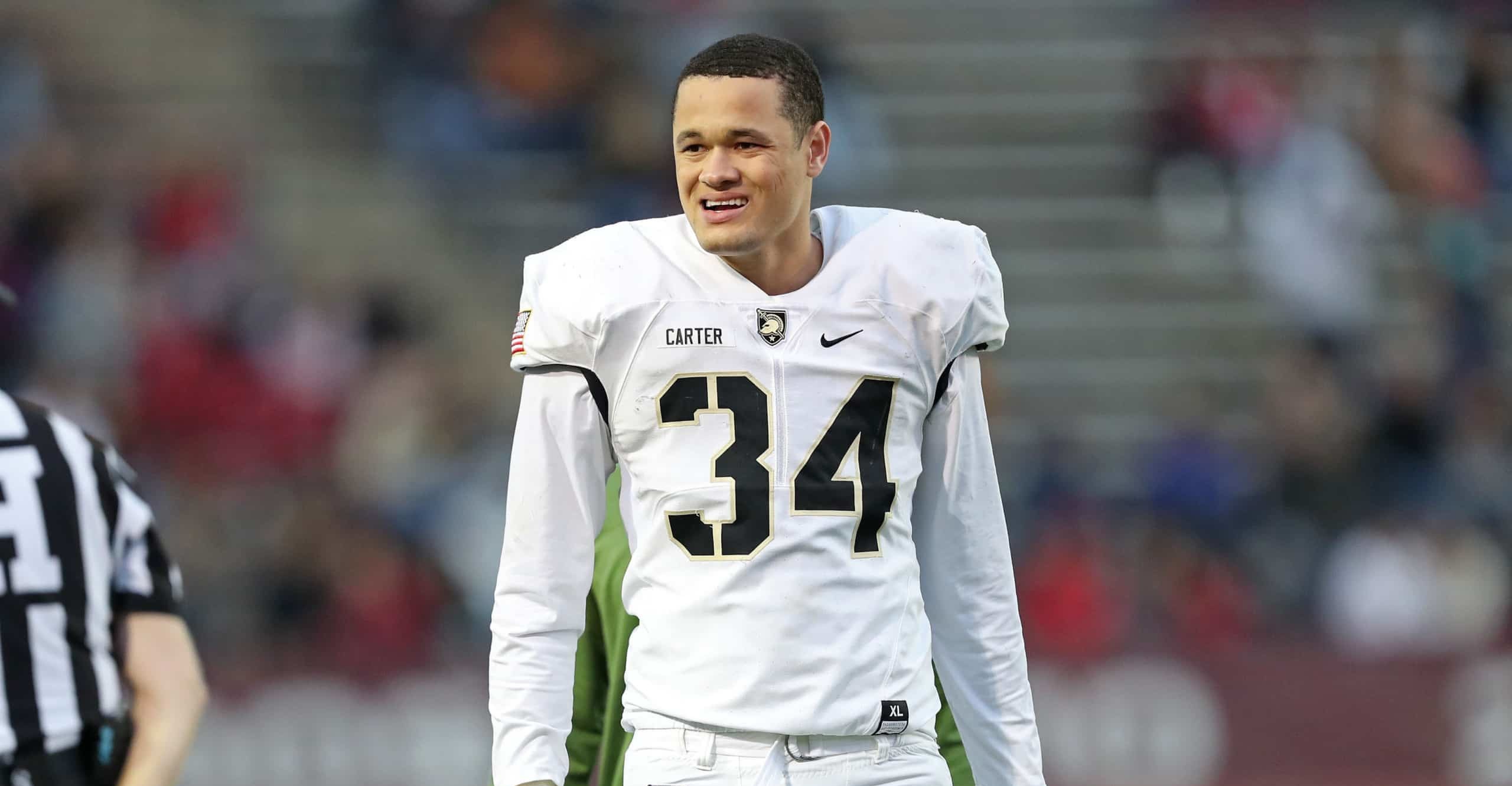 Army outside linebacker Andre Carter II standing on field before game