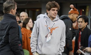 Texas commit Arch Manning standing on sideline during visit to school.