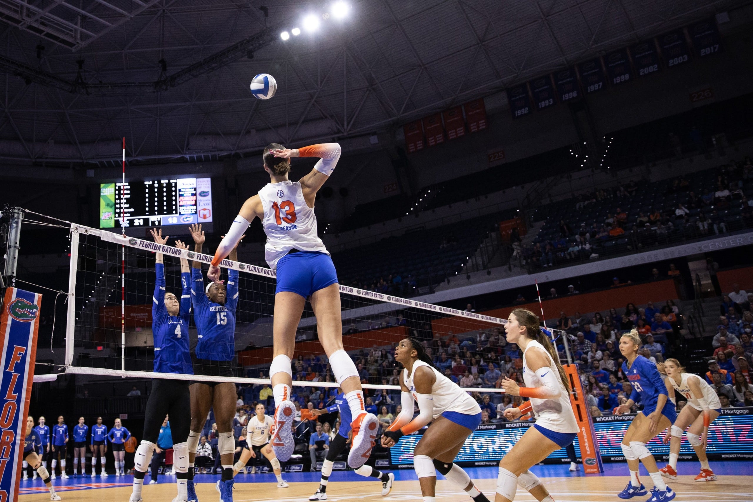 Florida Gators women's volleyball player prepares to spike ball against SEC opponents Kentucky