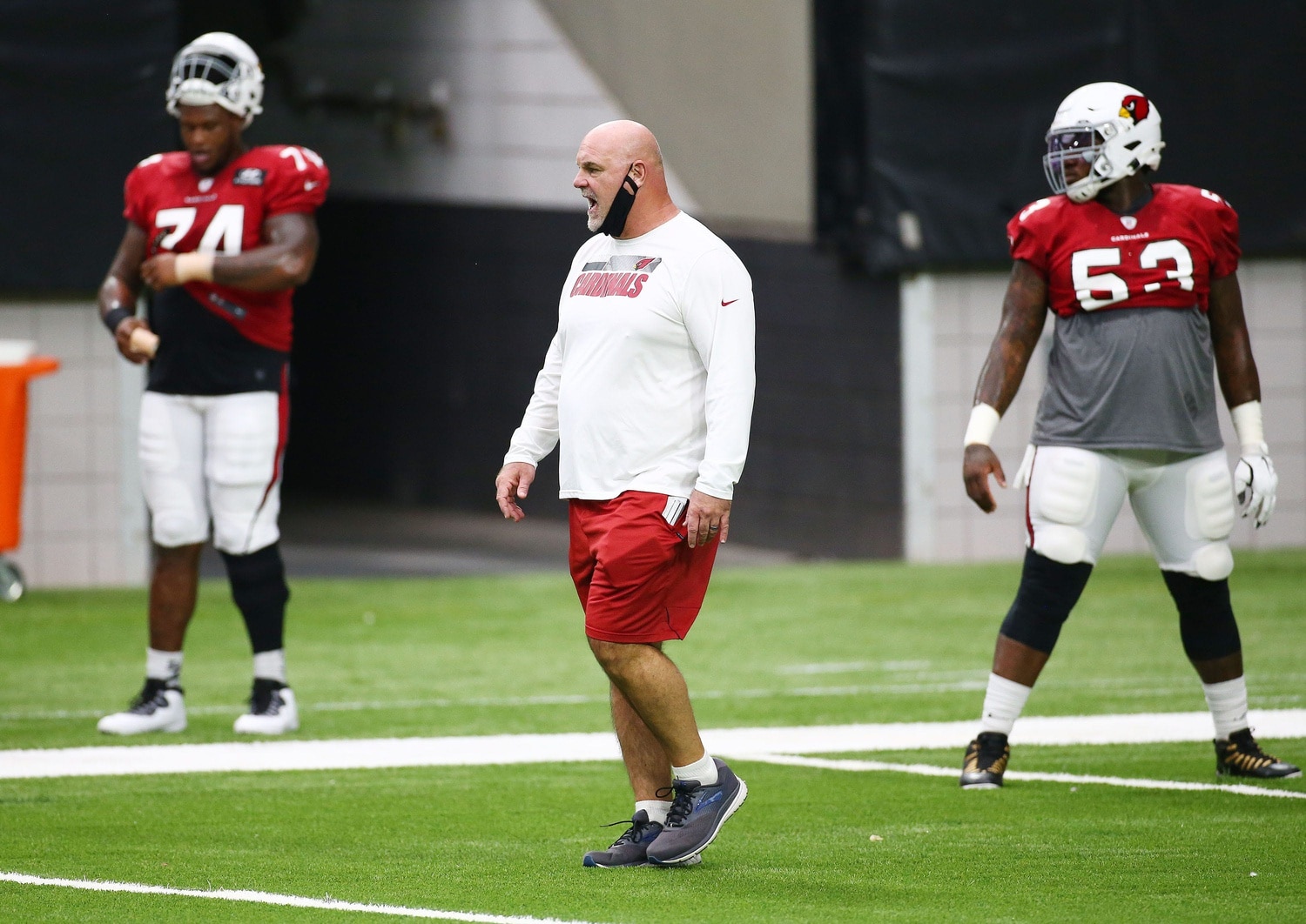 Arizona Cardinals offensive line coach Sean Kugler yells at players during stretch