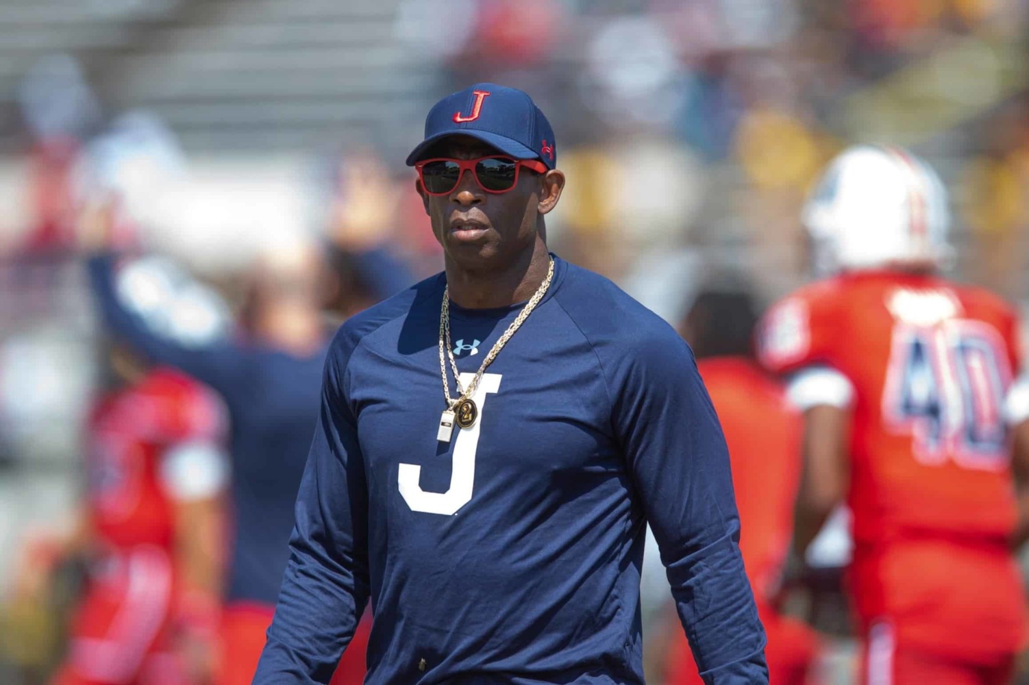 Deion Sanders walks between players during football practice at Jackson State