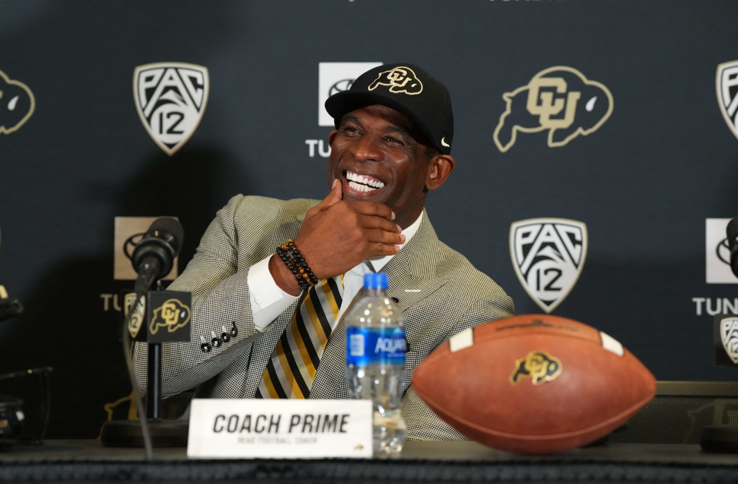 Deion Sanders smiles during press conference announcing his appointment as Colorado head coach