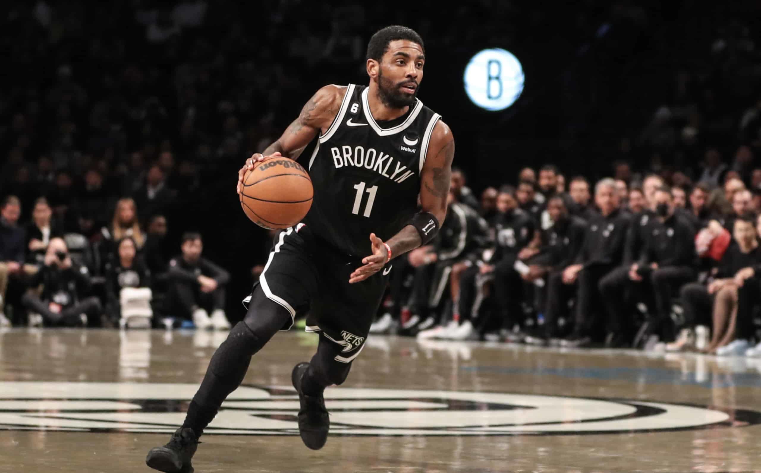 Kyrie Irving drives to basket while wearing all-black basketball shoes