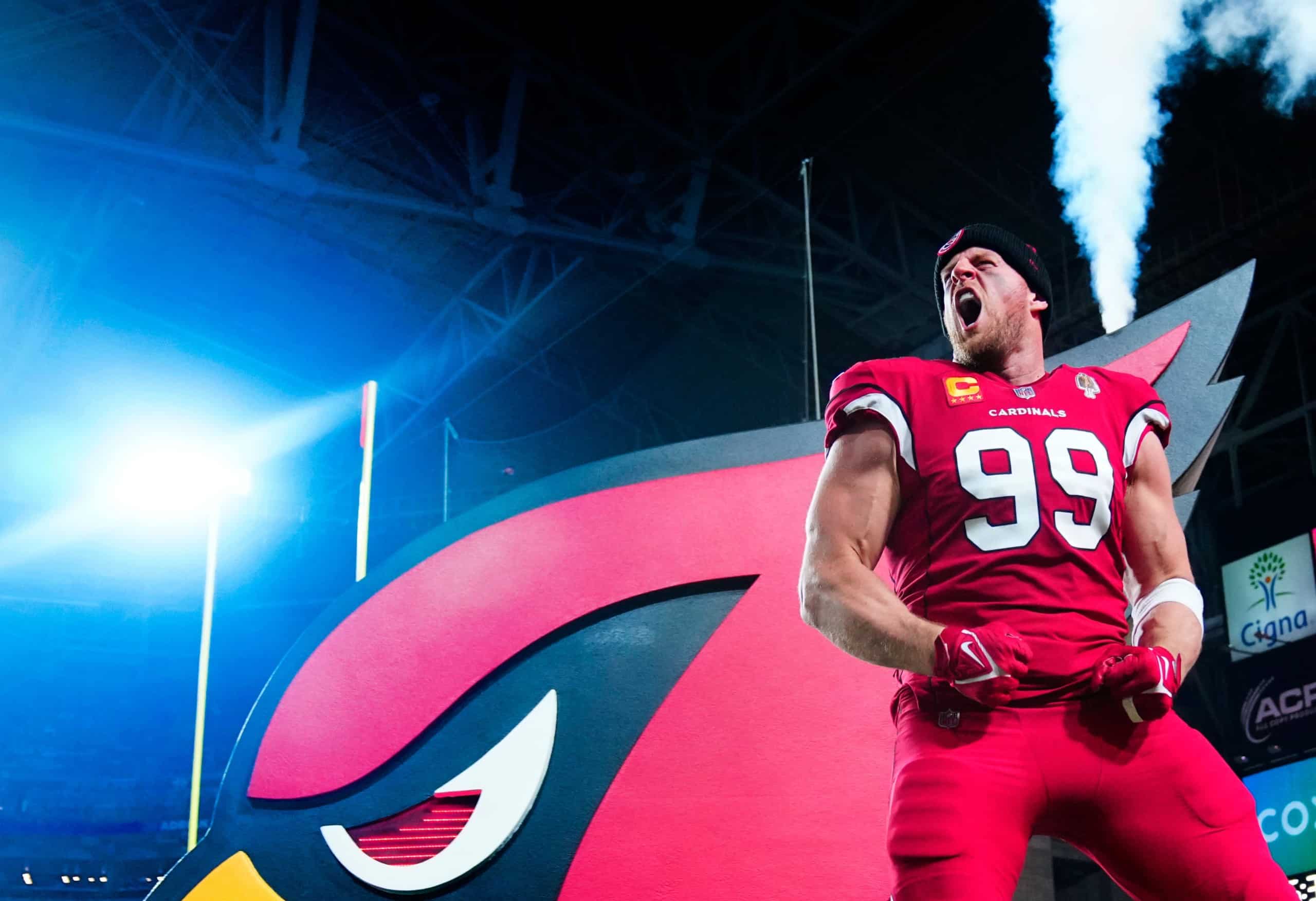 Arizona Cardinals player JJ Watt celebrates in front of team logo