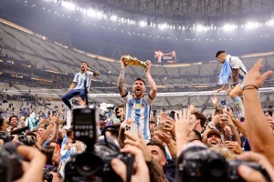 Lionel Messi hoists World Cup trophy in front of fans at Lusail Stadium in Qatar