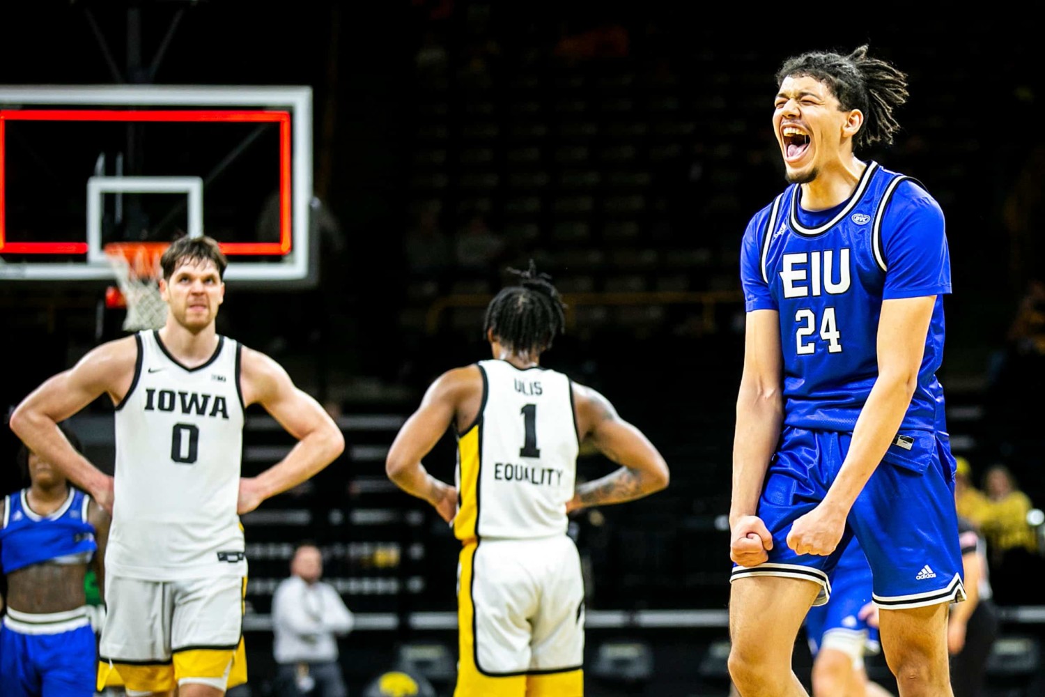 EIU players celebrate after beating Iowa in a mens college basketball matchup
