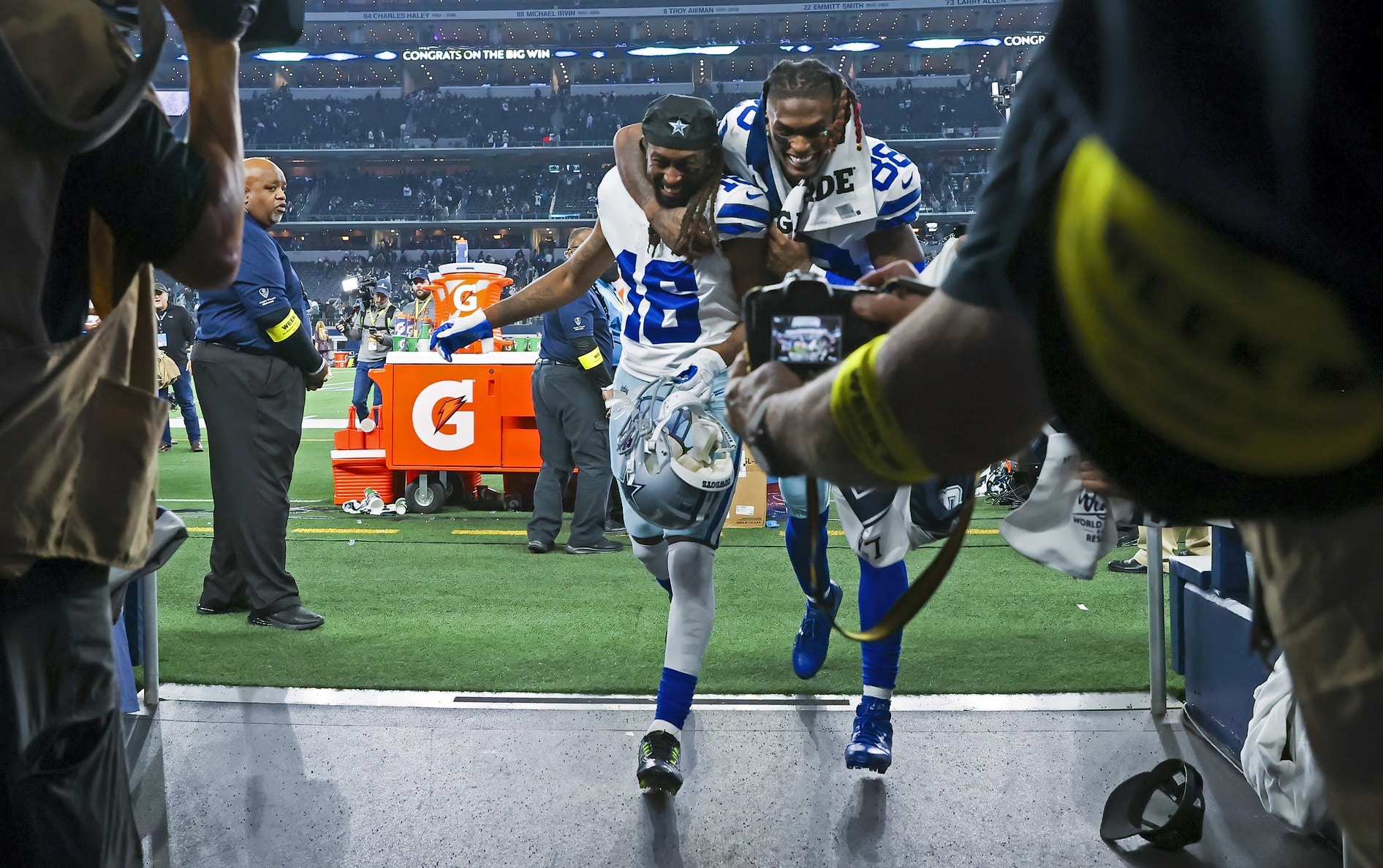Dallas Cowboys receivers celebrate while heading into tunnel