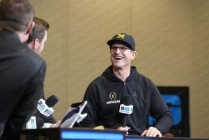 Jim Harbaugh laughs during pregame interview