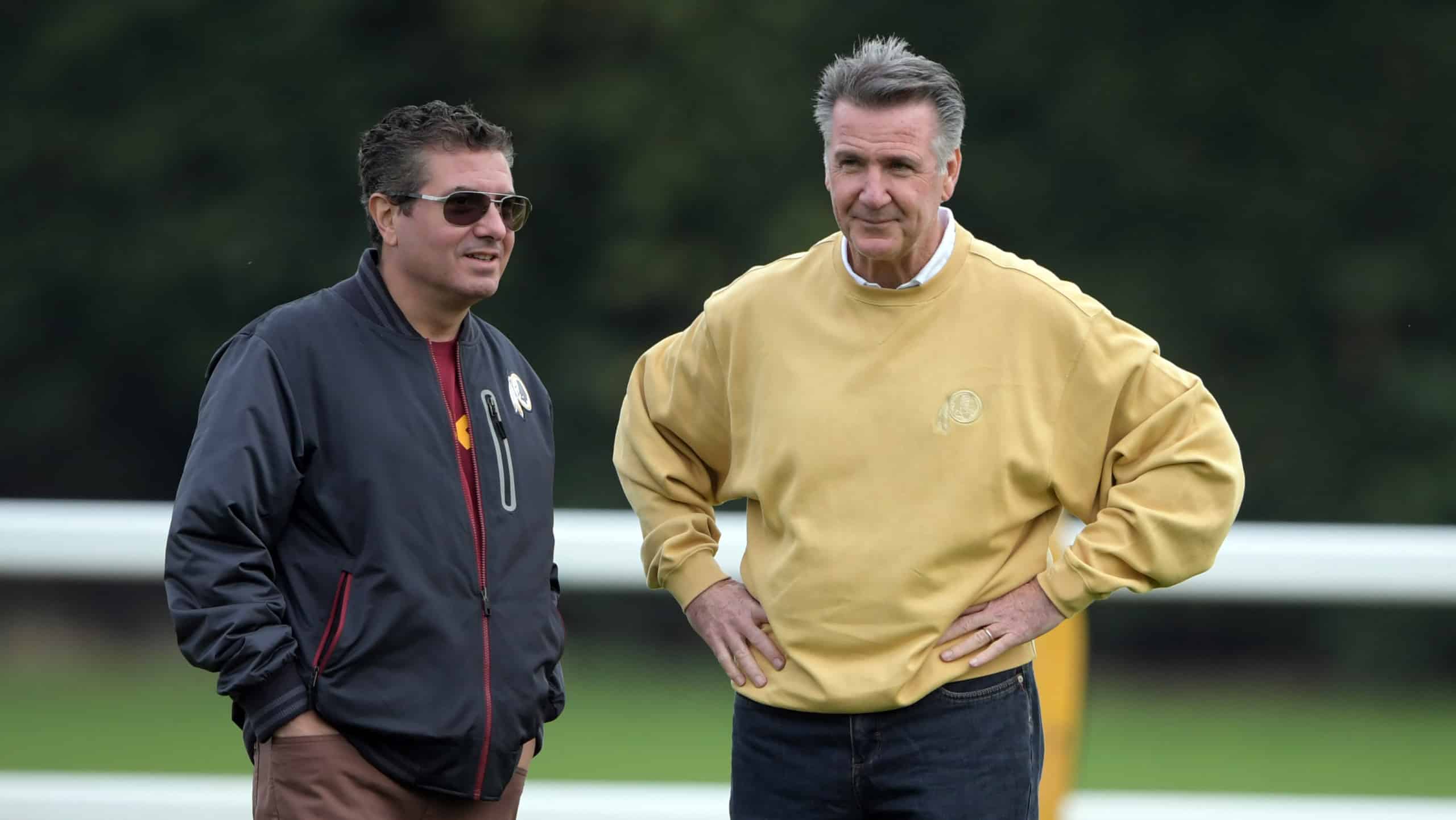Washington Commanders owner Dan Snyder stands next to former team executive Bruce Allen