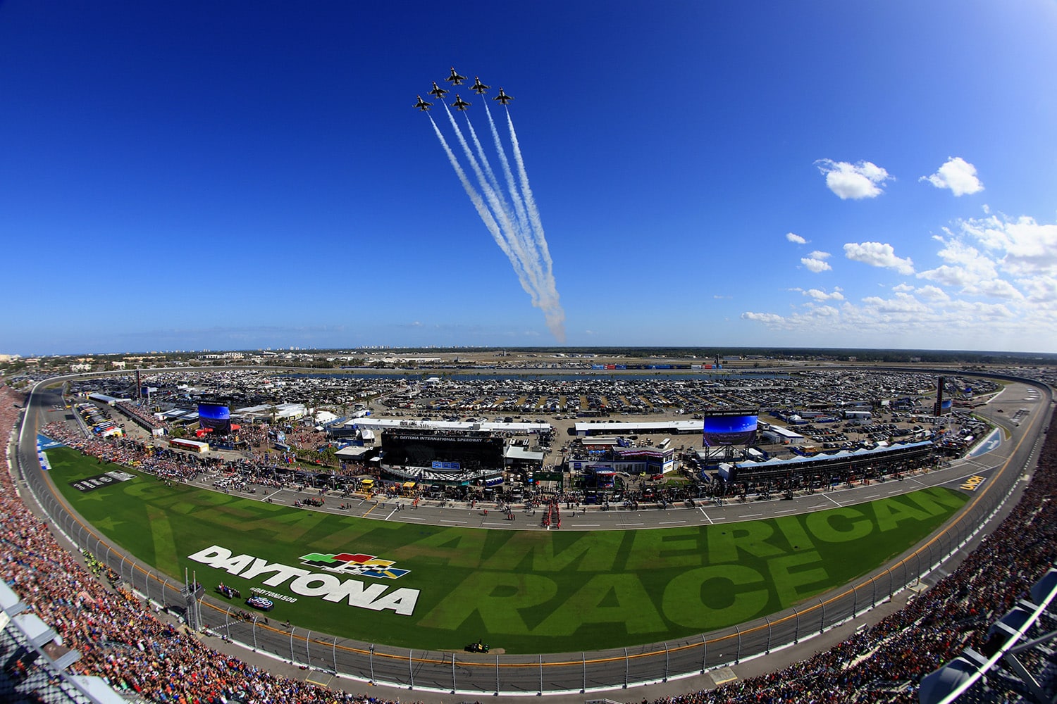 A view of the crowd, track, and fighter jet flyover before the Daytona 500.