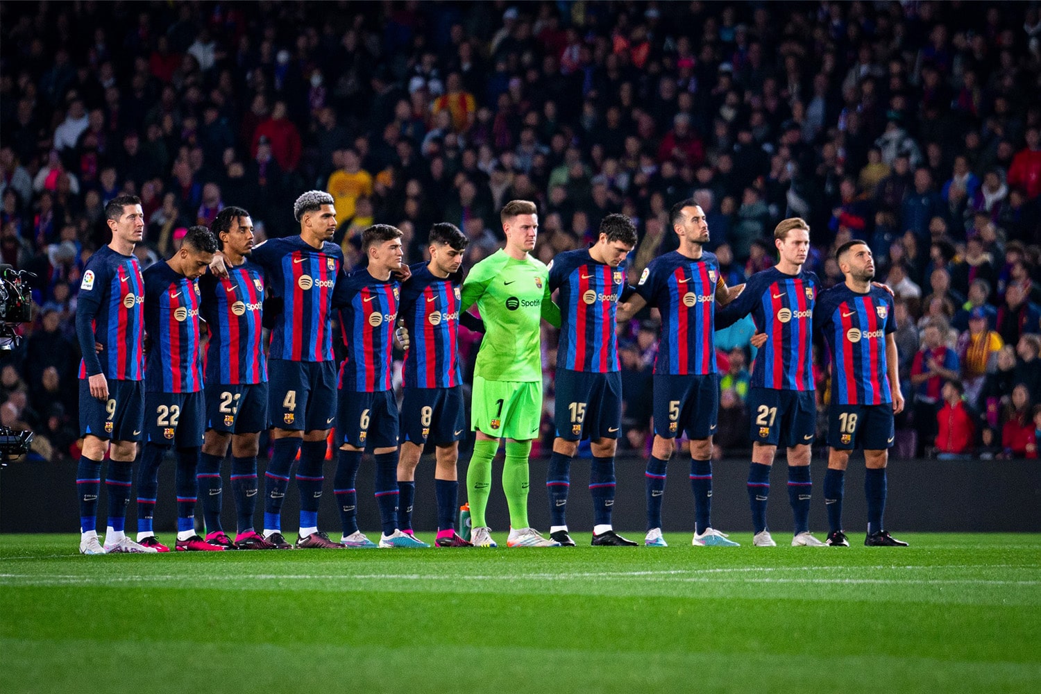 FC Barcelona players stand together on the field before a La Liga match.