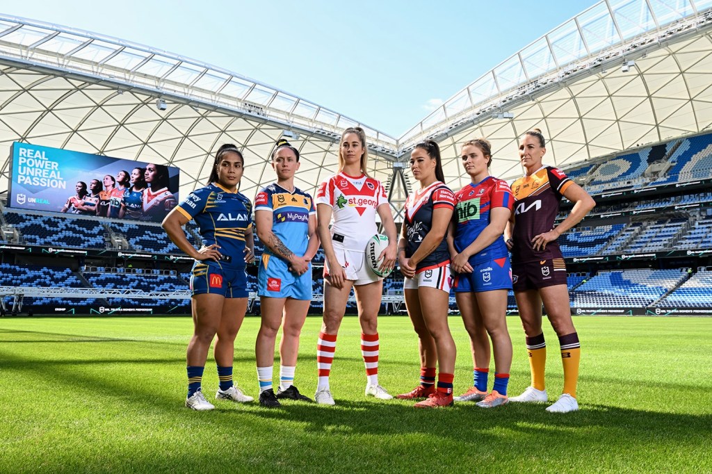 The National Rugby League Women's captains pose together for an on-field photo.