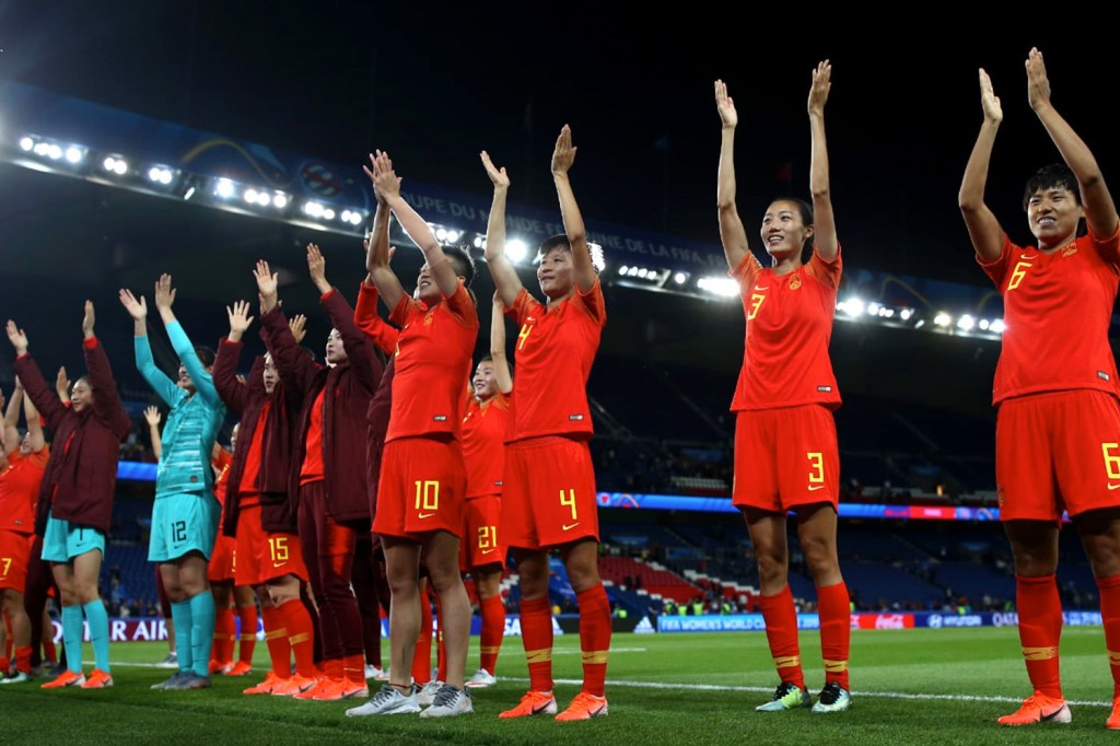 The China Women's National Soccer team clap for fans after a match.