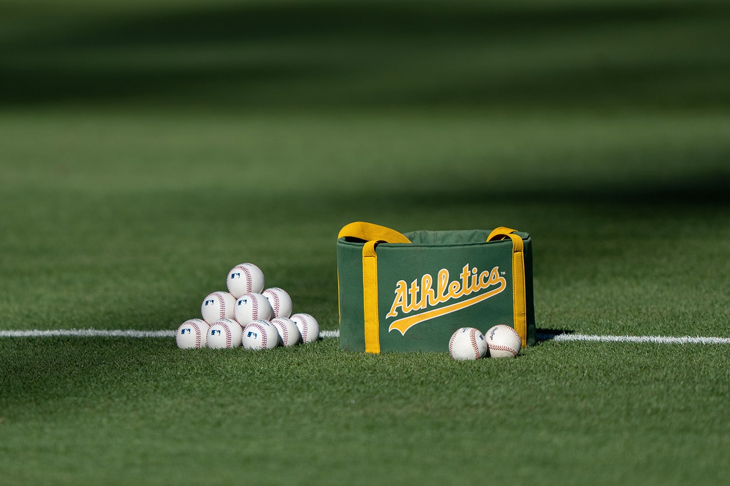 Baseball bag on field with Oakland Athletic's branding