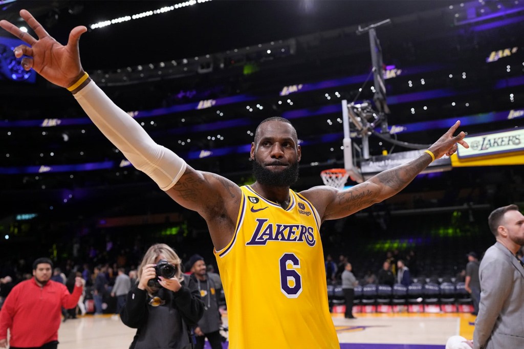 Lebron James gestures to the crowd with arms in the air