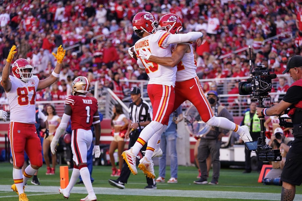 Kansas City Chiefs players celebrate in front of television camera