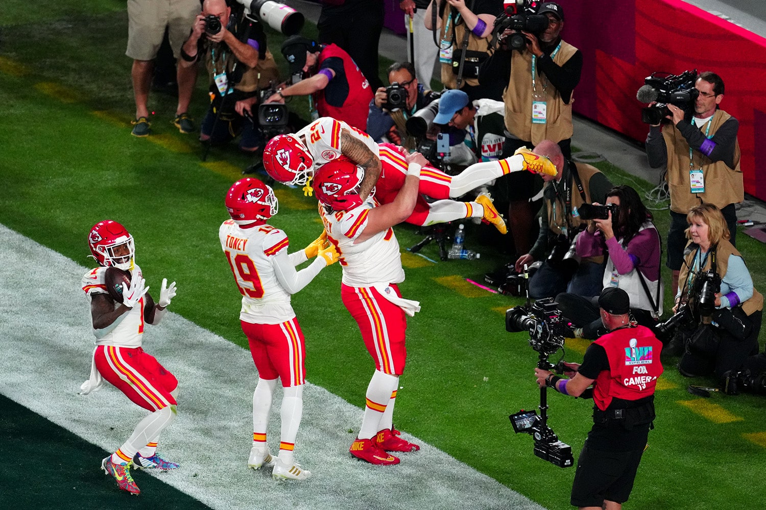 Kansas City Chiefs celebrate a touchdown in front of camera operator during Super Bowl LVII.