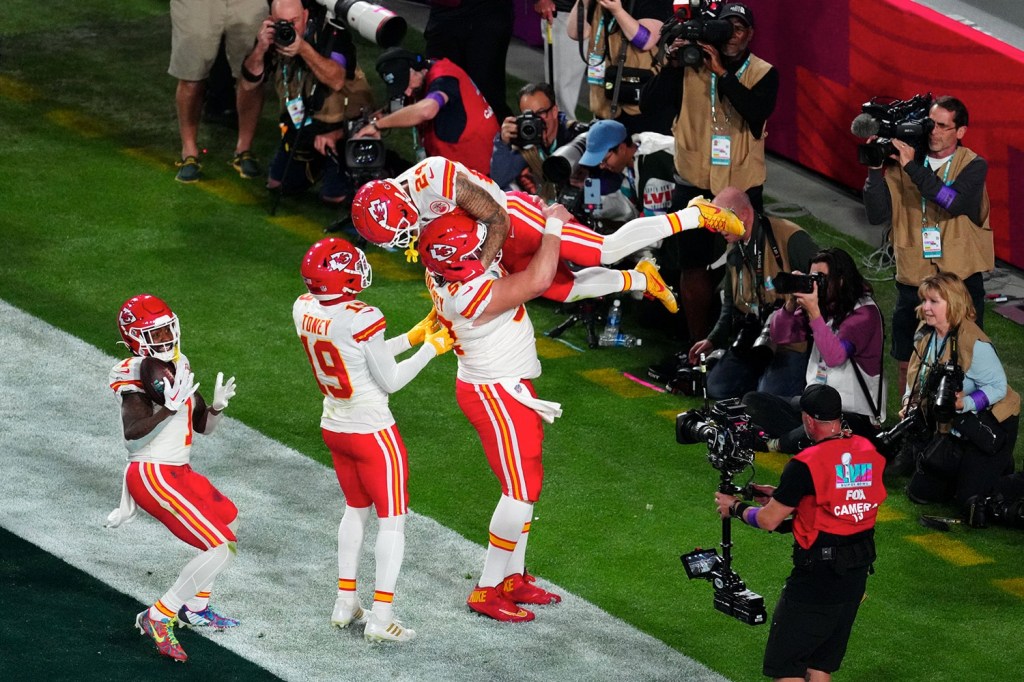 Kansas City Chiefs celebrate a touchdown in front of camera operator during Super Bowl LVII.