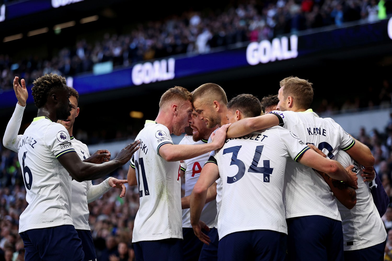 Tottenham Hotspur FC players celebrate together after a goal.