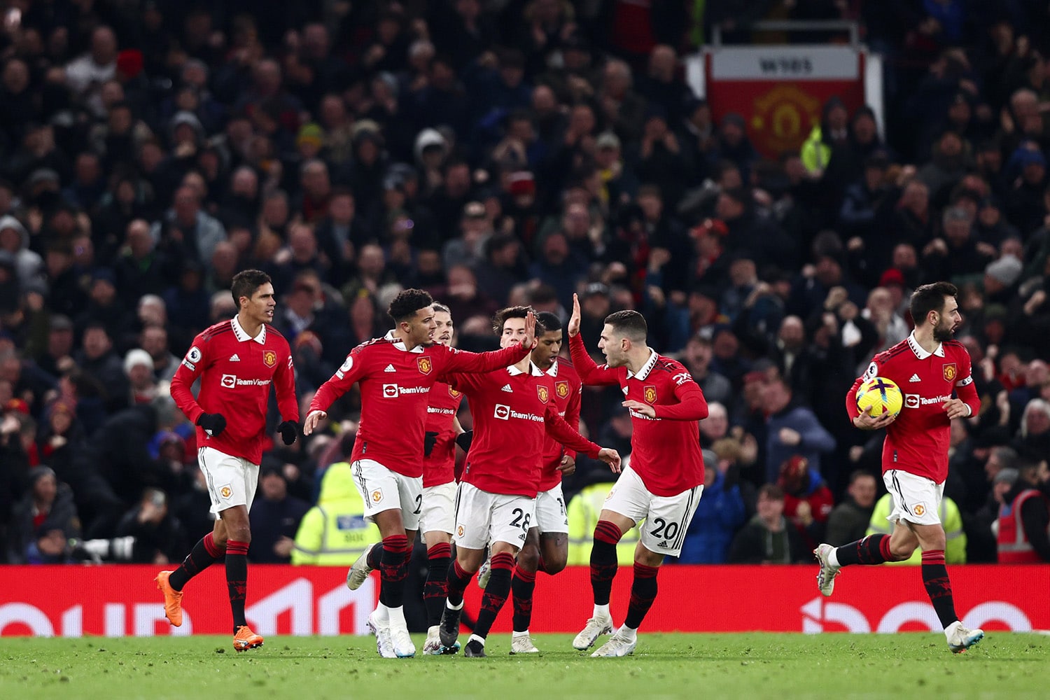 Manchester United players celebrate together after Jadon Sancho scores a goal in the Premier League at Old Trafford.