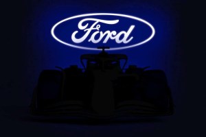 Silhouette of Ford's Formula 1 car in front of Ford logo