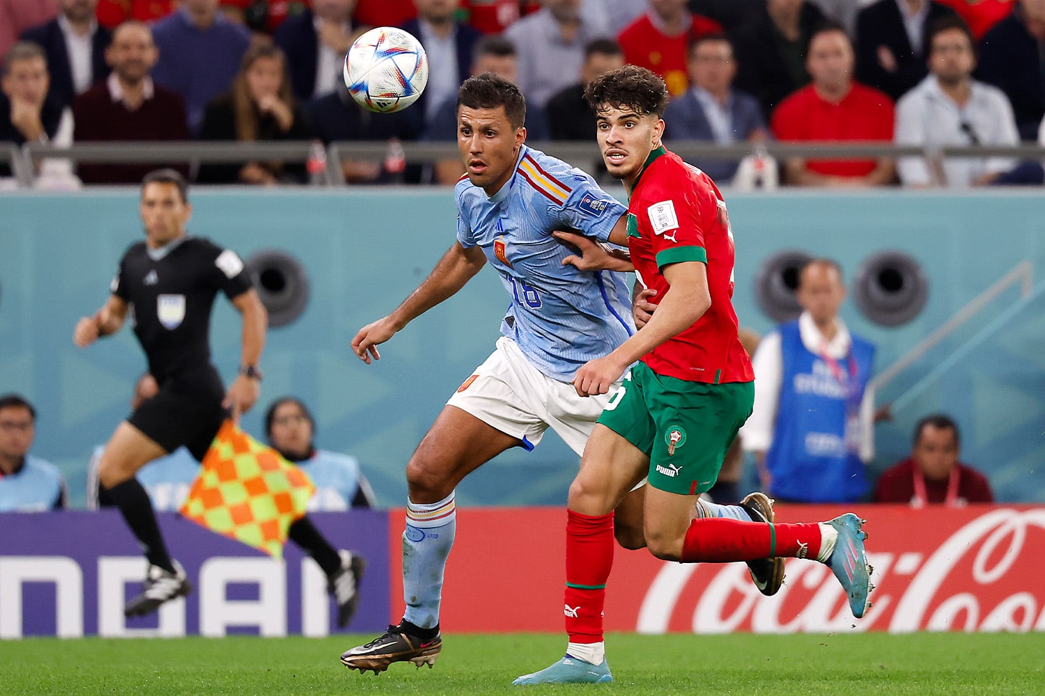 A Spain and Morocco player fight for the ball during their round of sixteen match at the 2022 FIFA World Cup.