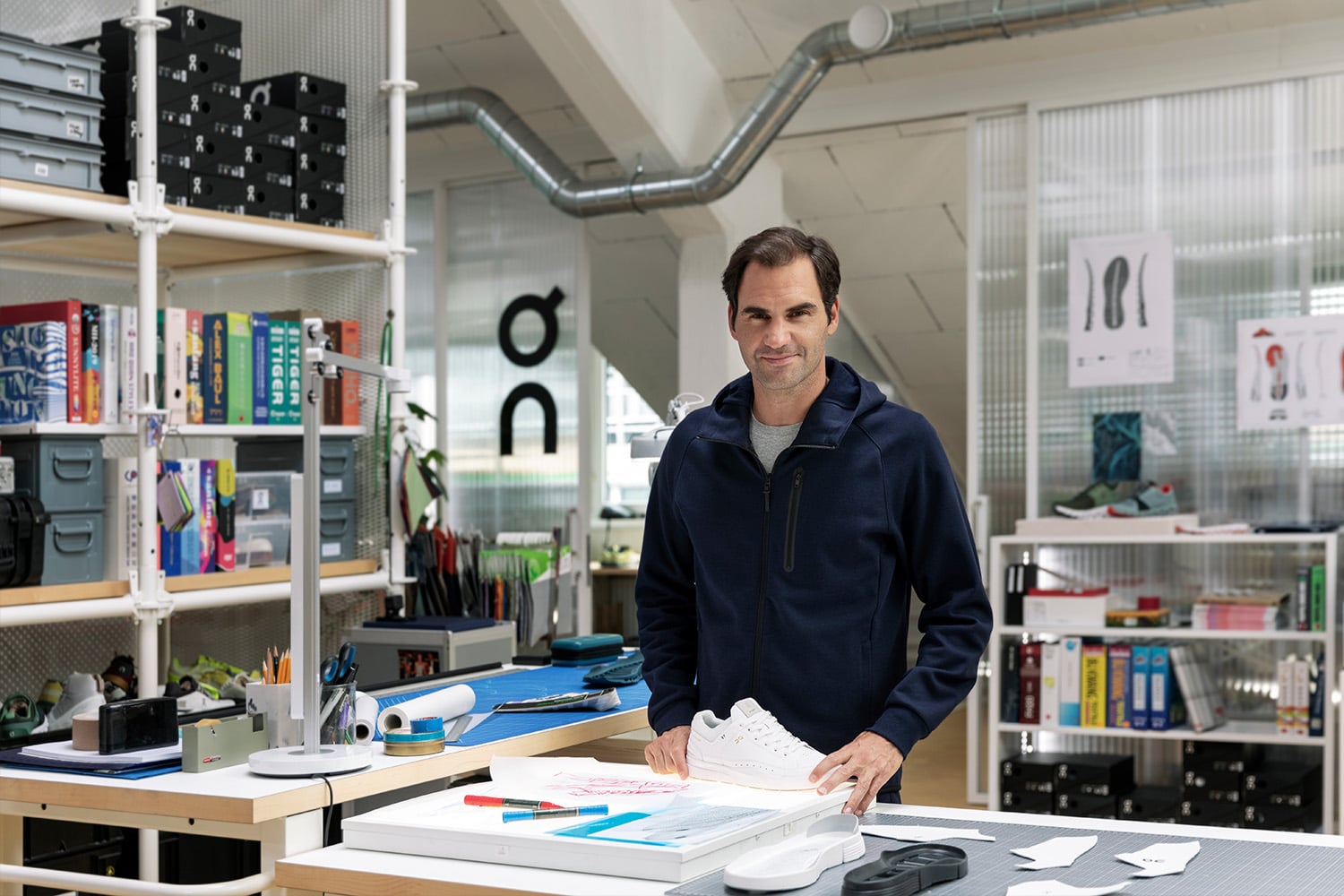 Roger Federer in the On design lab with his signature tennis shoe.