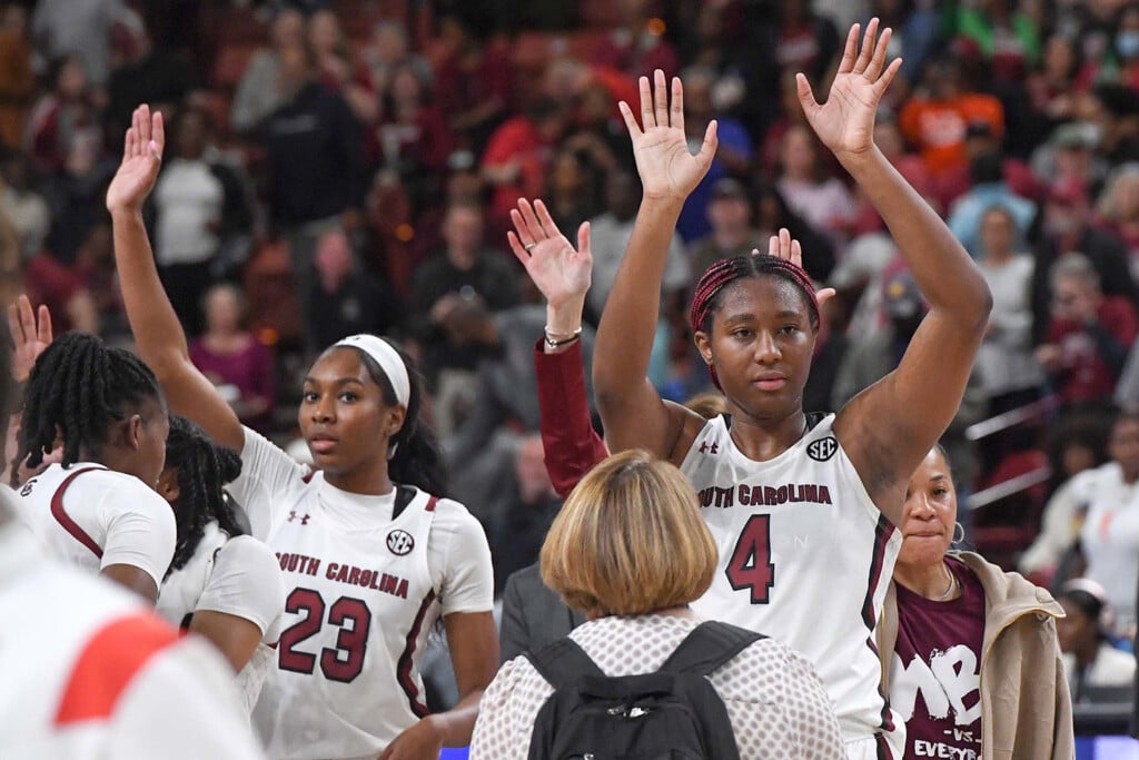 The South Carolina women's basketball team waves to the crowd at a game.