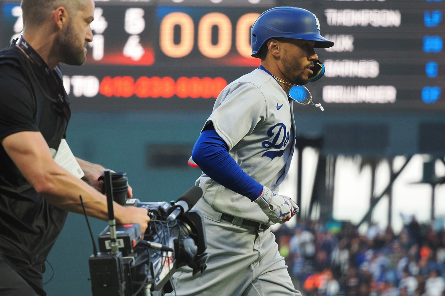 Los Angeles Dodgers right fielder Mookie Betts is followed by a MLB television camera.