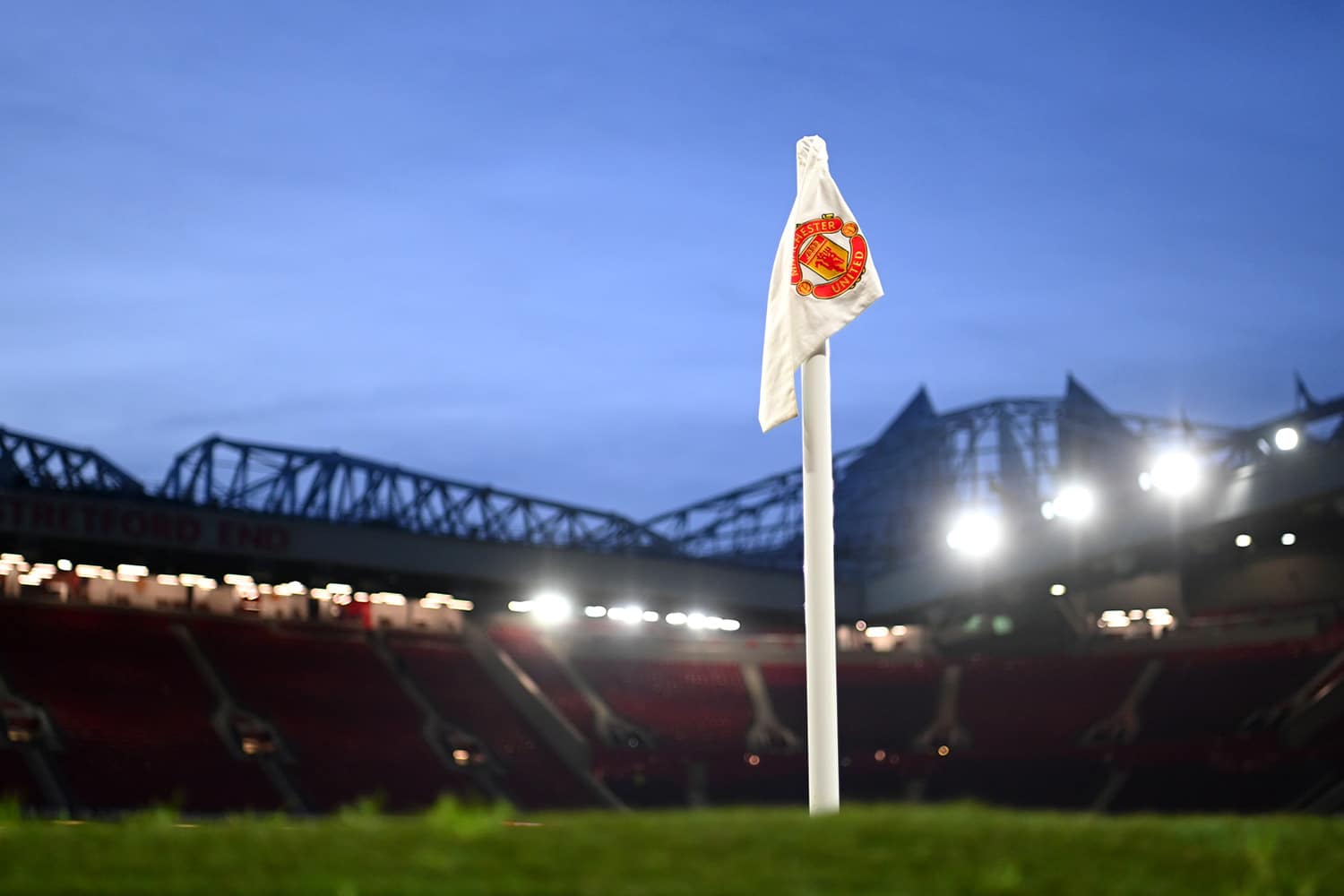 View of a Manchester United corner flag at Old Trafford stadium.
