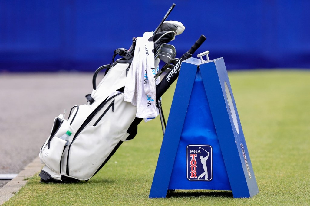 Golf bag leaning on PGA Tour signage