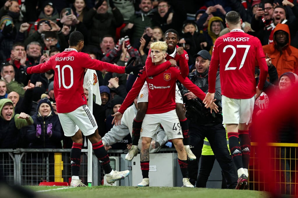 Manchester United players celebrate together after a goal
