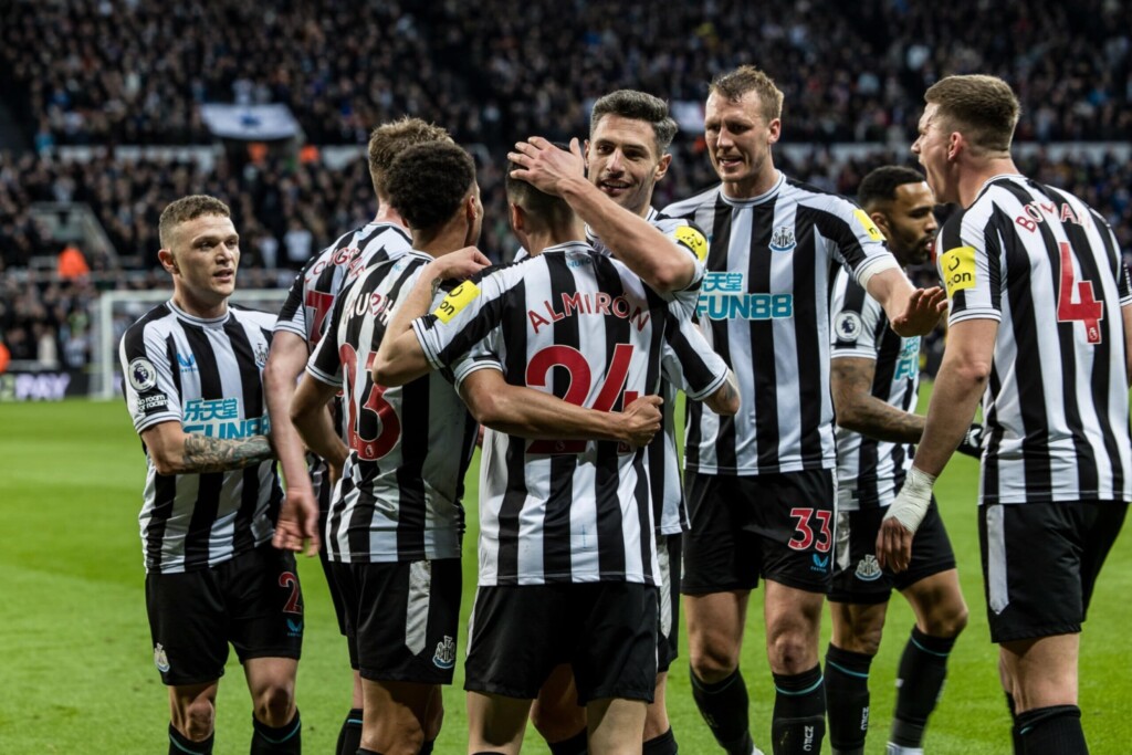 Newcastle United FC players celebrate after scoring a goal.