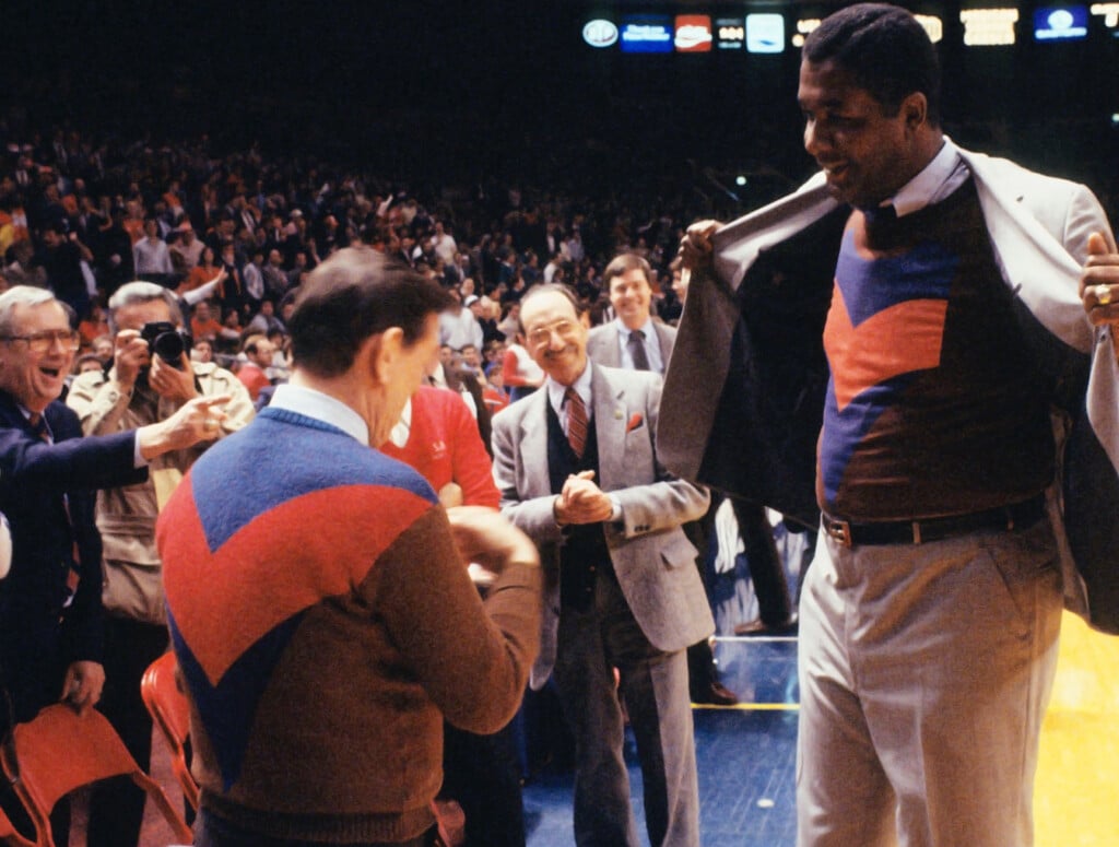 02/27/1985 No. 2 ranked Georgetown Hoyas defeated No. 1 ranked St. John's Red Storm, 85-69, in "sweater game," when Georgetown coach John Thompson (right) wears a sweater that matches St. Johns coach Lou Carnesecca's lucky sweater.