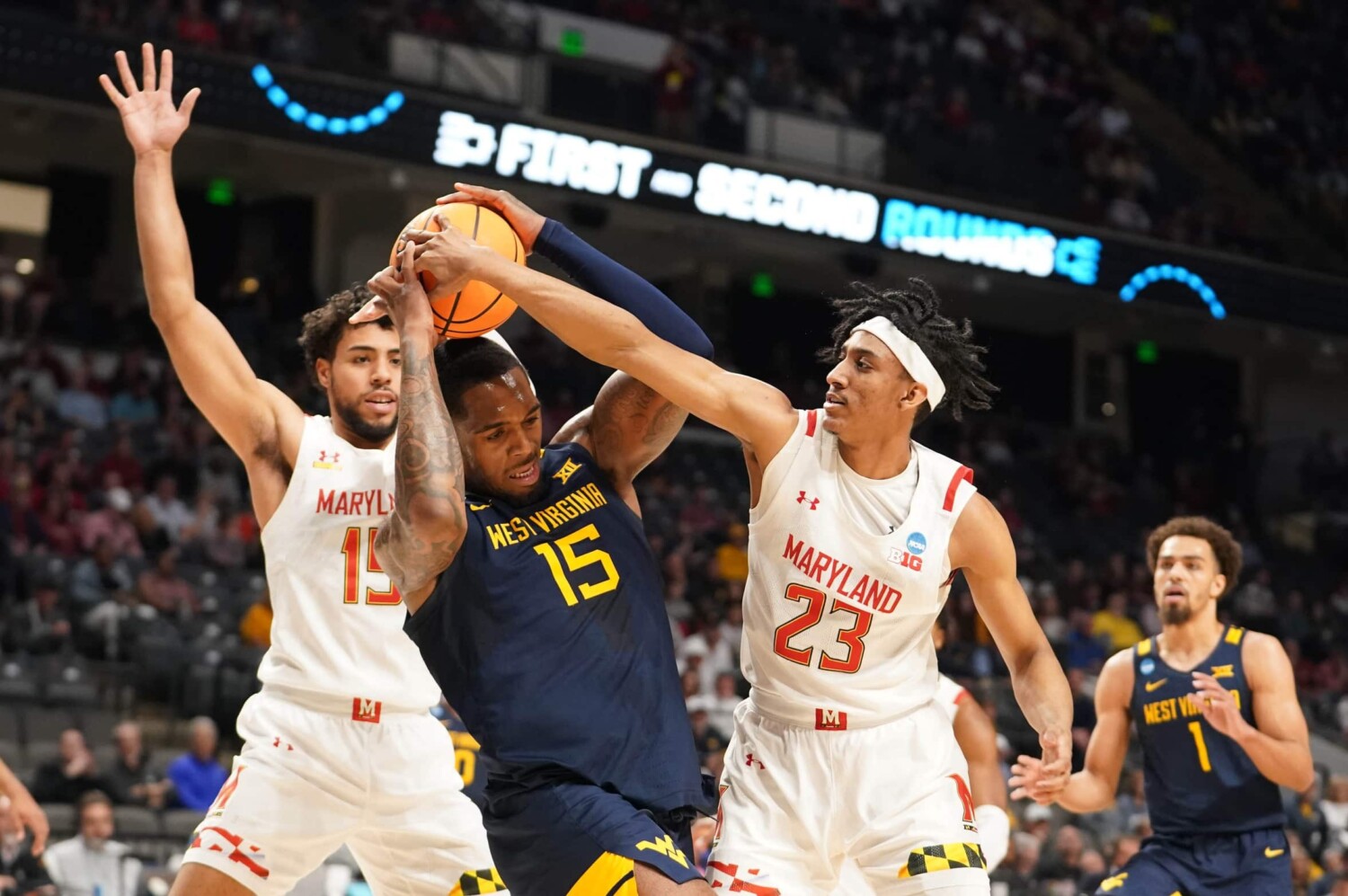 West Virginia Mountaineers forward Jimmy Bell Jr. (15) battles for the ball between Maryland Terrapins guard Ian Martinez (23) and forward Patrick Emilien (15) during the first half in the first round of the 2023 NCAA Tournament at Legacy Arena.
