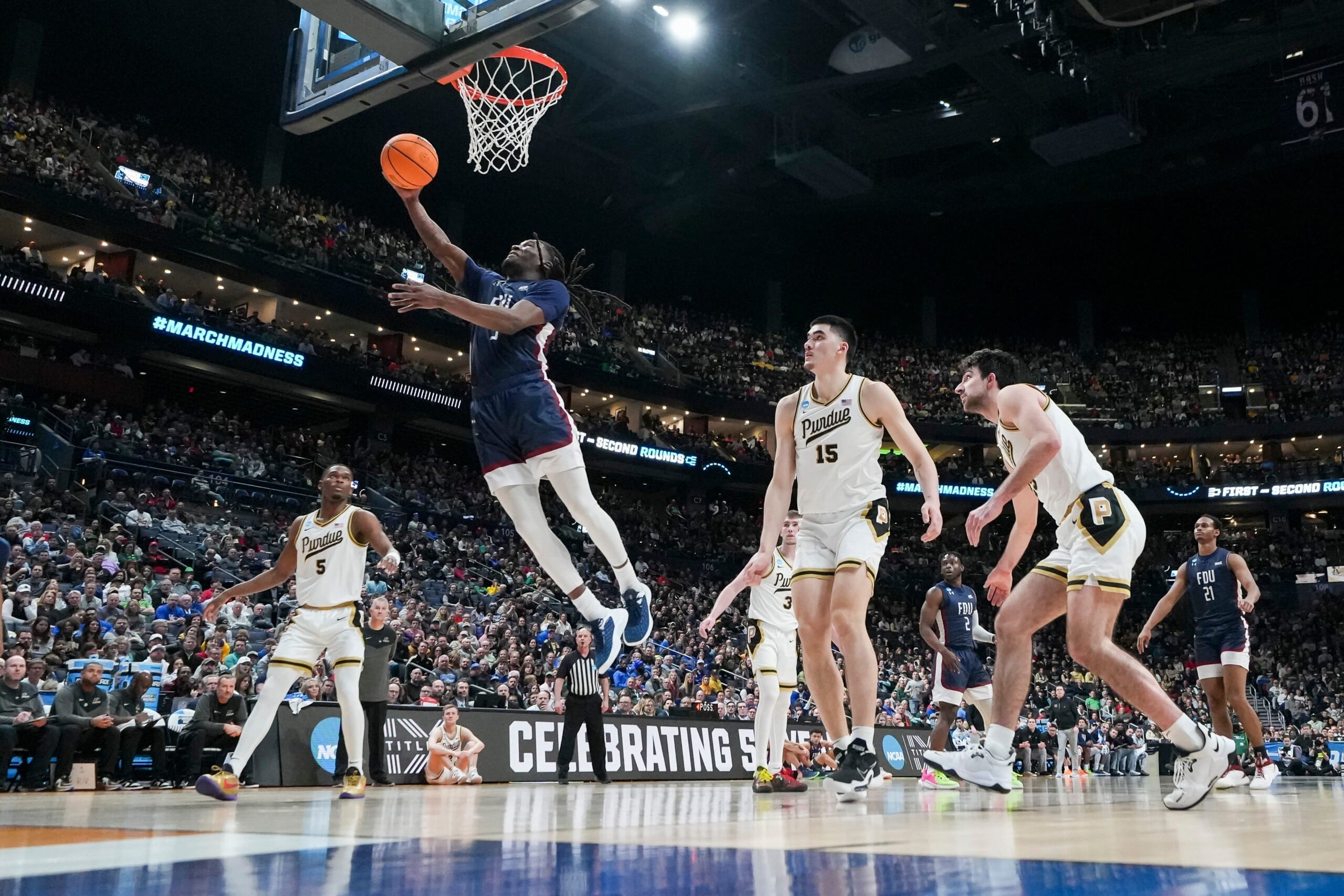 Mar 17, 2023; Columbus, Ohio, USA; Fairleigh Dickinson Knights guard Heru Bligen (3) makes a layup in front of Purdue Boilermakers center Zach Edey (15) during the first round of the NCAA men’s basketball tournament at Nationwide Arena.