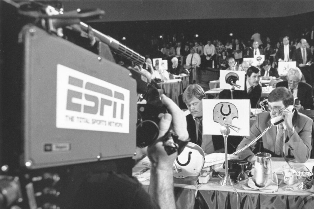 An ESPN camera films the Indianapolis table at the 1990 NFL Draft.